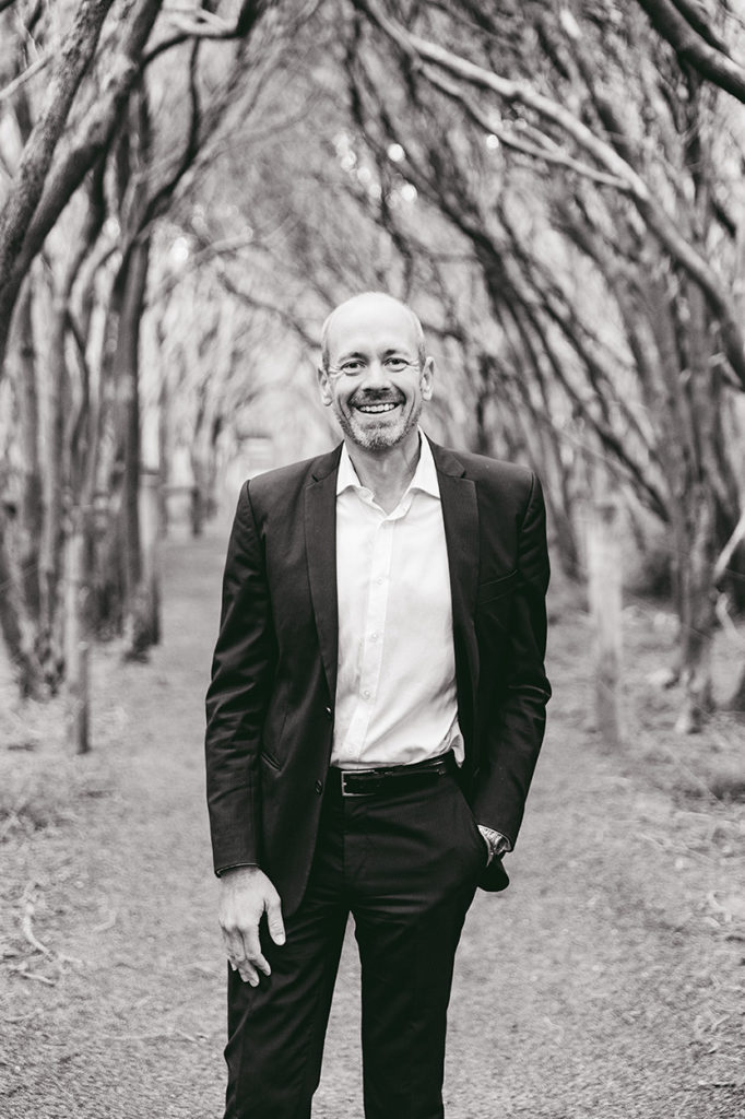 man with suit on smiling at camera